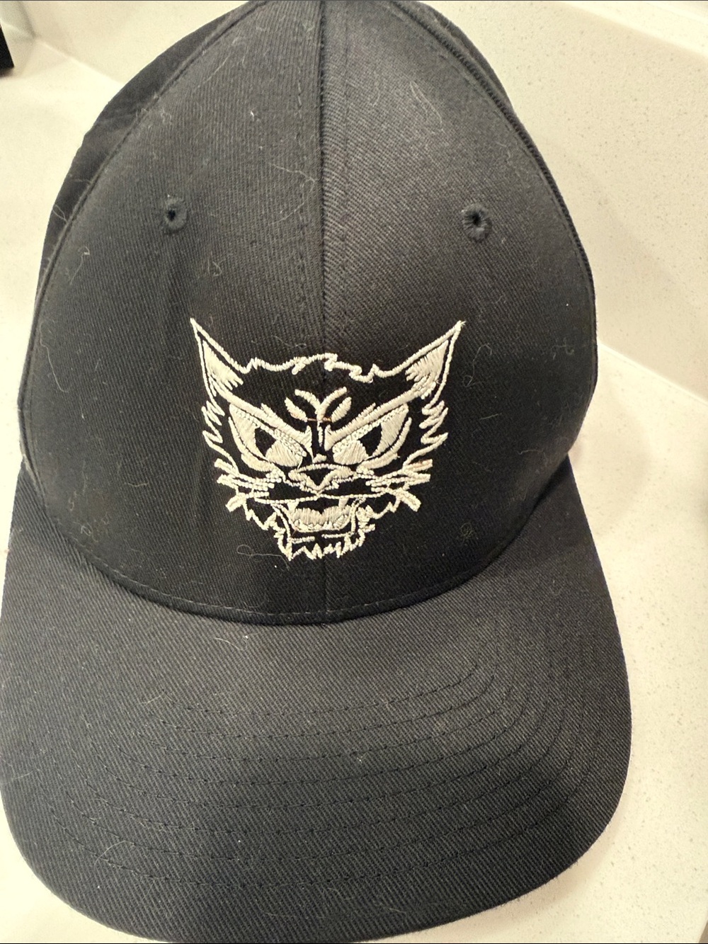 MEAN EYED CAT (AUSTIN TX) Black Cap with White Angry Cat Embroidery